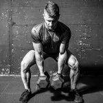 Muscular-athlete-performing-a-dumbbell-squat-for-a-hybrid-training-program