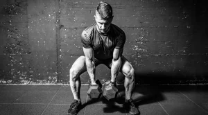 Muscular-athlete-performing-a-dumbbell-squat-for-a-hybrid-training-program